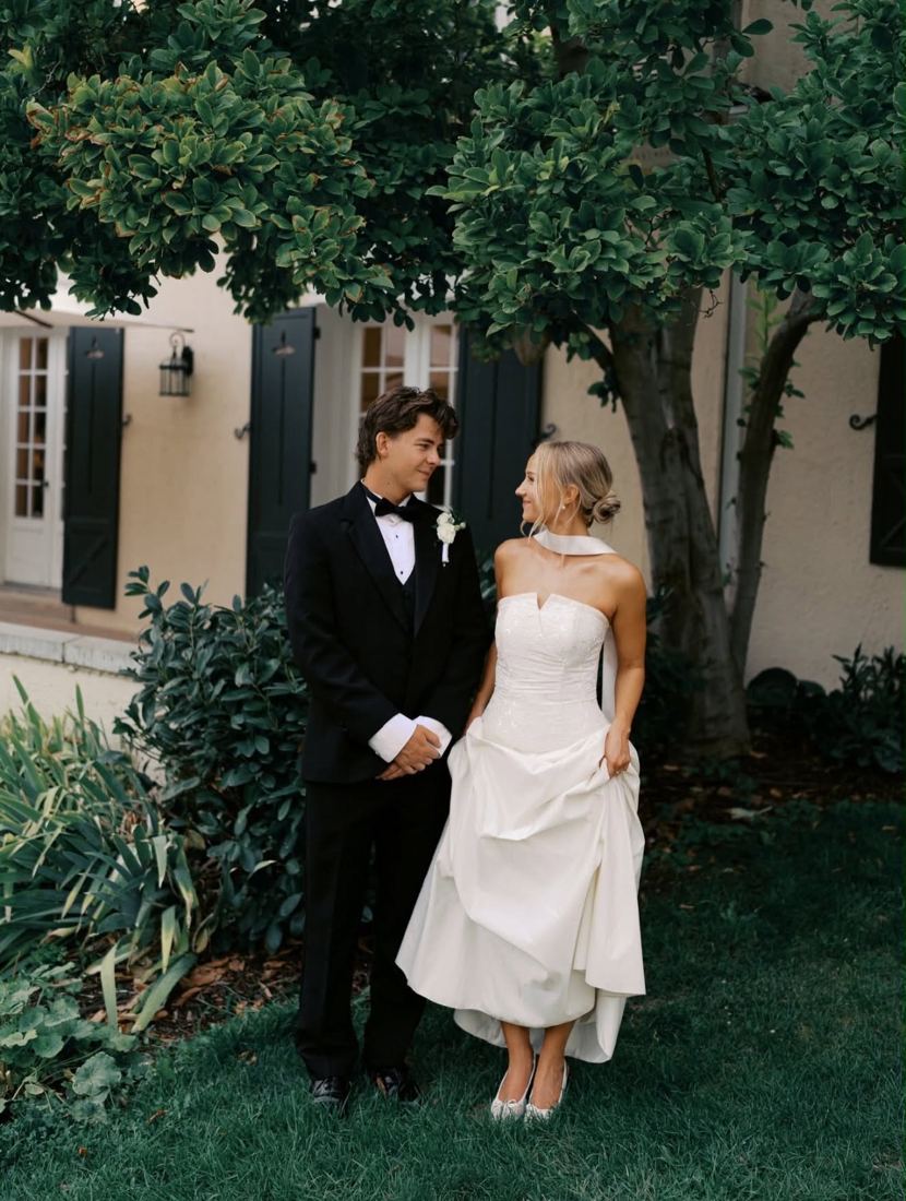 Bride with a soft low chignon in a garden courtyard